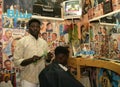 A Sudanese refugee working in a barber shop