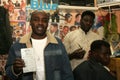 A Sudanese refugee working in a barber shop