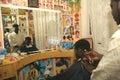 A Sudanese refugee working in a barber shop