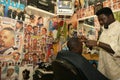 A Sudanese refugee working in a barber shop