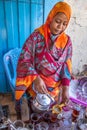 Sudanese woman pouring tea.