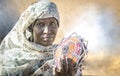 Sudanese woman selling souvenirs in a desert