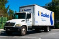 Suddath Relocation Systems truck waits for customer on outdoor parking lot.