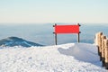 Sudetes, a red board on the top of the mountain, a winter mountain landscape, a view from the top of Mount Snieznik