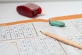 Sudoku Puzzle. Pen and pen sharpener and eraser. Royalty Free Stock Photo