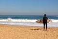 Sufer looking at surf at Beach Vina del Mar, Chile.