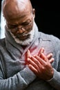 Suffering from chest pains. a handsome senior man holding his chest in pain. Royalty Free Stock Photo