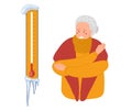 Suffering from cold. Senior woman looking with anger at thermometer from which icicle hangs and trying to keep warm with