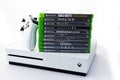 Suffolk, UK June 01 2020: A Microsoft Xbox One S gaming console with a wireless controller and a stack of games shot against a Royalty Free Stock Photo