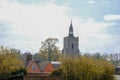 Village church tower nad orange medieval house Royalty Free Stock Photo