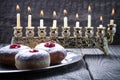 Sufganiyot and nine branched menora for Hanukkah Royalty Free Stock Photo