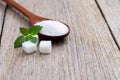 White sugar and Stevia leaf isolated on wood table .