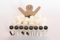 Figure of a cardboard man surrounded by refined sugar cubes and bottles of insulin on white background, diabetes protection