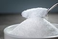 Sugar being poured from spoon into a bowl Empty ready for your p Royalty Free Stock Photo