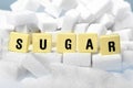 Sugar block letters word on pile of sugar cubes close up in addiction concept Royalty Free Stock Photo