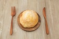 sugar bread melon pan on wood plate fork knife  on table Royalty Free Stock Photo