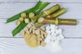 Sugar cane with brown and white sugar cubes on wood background / Close up Sugarcane Royalty Free Stock Photo