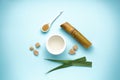 Sugar cane juice and brown sugar on blue background. Top view
