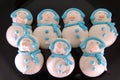 Sugar Christmas snowmen figurines on glazed muffins Royalty Free Stock Photo