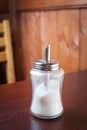 Sugar container on brown table