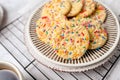 Sugar cookies with sprinkles, colorful coffee treat. Royalty Free Stock Photo