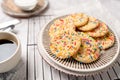 Sugar cookies with sprinkles, colorful coffee treat. Royalty Free Stock Photo