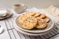 Sugar cookies with sprinkles, colorful coffee treat. Royalty Free Stock Photo