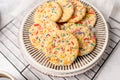 Sugar cookies with sprinkles, colorful coffee treat. Royalty Free Stock Photo