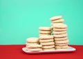 Sugar cookies stacked at various heights on a white plate