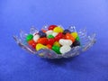 Jelly beans candy in a plate a blue background Royalty Free Stock Photo