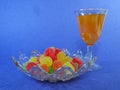 Gummy candy in a plate a blue background mimosa cocktails Royalty Free Stock Photo