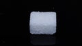 A sugar cube on a black background Royalty Free Stock Photo