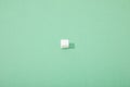 Sugar cube on green background with copy space Royalty Free Stock Photo