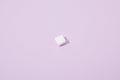 Sugar cube on violet background with copy space Royalty Free Stock Photo