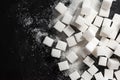 Sugar cubes on a black background. Cubic sugar background with copy space. Top view