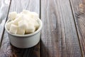 Sugar cubes in ceramic bowl on wooden table Royalty Free Stock Photo