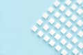 Sugar cubes pattern on blue background with copy space Top view