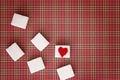 Sugar cubes with a red heart on one of them. Top view. Diet unhealty sweet addiction concept Royalty Free Stock Photo