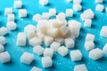 sugar cubes scattered on a bright blue background, neural network generated photorealistic image