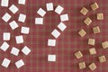 Sugar cubes shaped as a question mark on red squared background. Top view. Diet unhealty sweet addiction concept Royalty Free Stock Photo