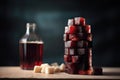 sugar cubes stacked high against a blurred bottle of cola