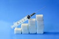 Sugar cubes with syringe. Diabetes concept. The concept of possible harm from sugar. Increase in blood sugar levels, the graph of