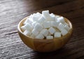 Sugar cubes in wood bowl on wood Royalty Free Stock Photo
