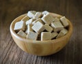 Sugar cubes in wooden bowl placed on the wooden table Royalty Free Stock Photo