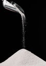 sugar falling from metal scoop on pile Royalty Free Stock Photo