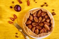 Sugar free pie with plums and raisins on a white plate on yellow wooden background decorated with fresh plums, brown raisins Royalty Free Stock Photo