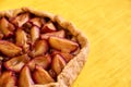 Sugar free pie with plums and raisins on yellow wooden background close up with copy space on the right side Royalty Free Stock Photo