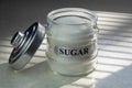 Sugar glass canister. White container with the word sugar in black font.