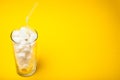 Sugar in a glass with a straw, empty space for text on a yellow background