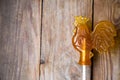 Sugar lollipop rooster on wooden background